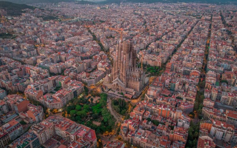 Stunning aerial view of the Sagrada Familia amidst the urban landscape of Barcelona, Spain.