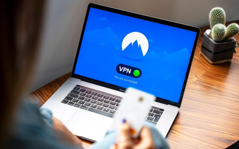 A person using a VPN on a laptop, symbolizing secure internet browsing in a modern indoor setting.