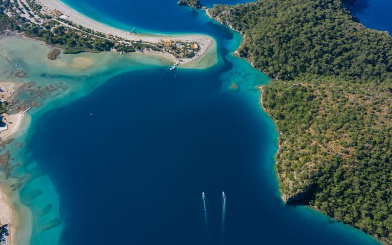 Stunning aerial view of a tropical coastline with turquoise waters and lush greenery.
