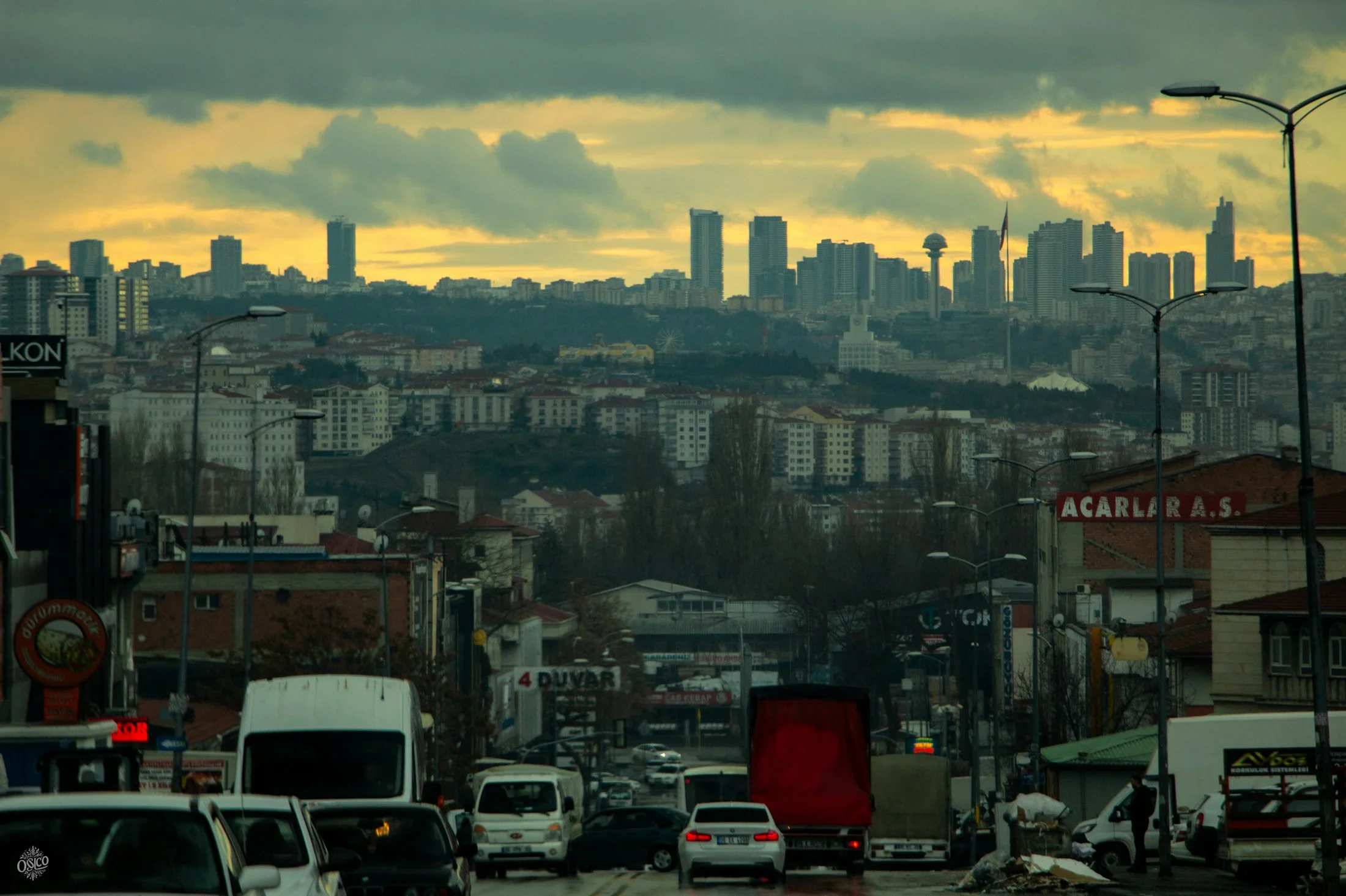 Bulutlu bir akşamda Ankara şehir silueti ve yoldaki araçlar