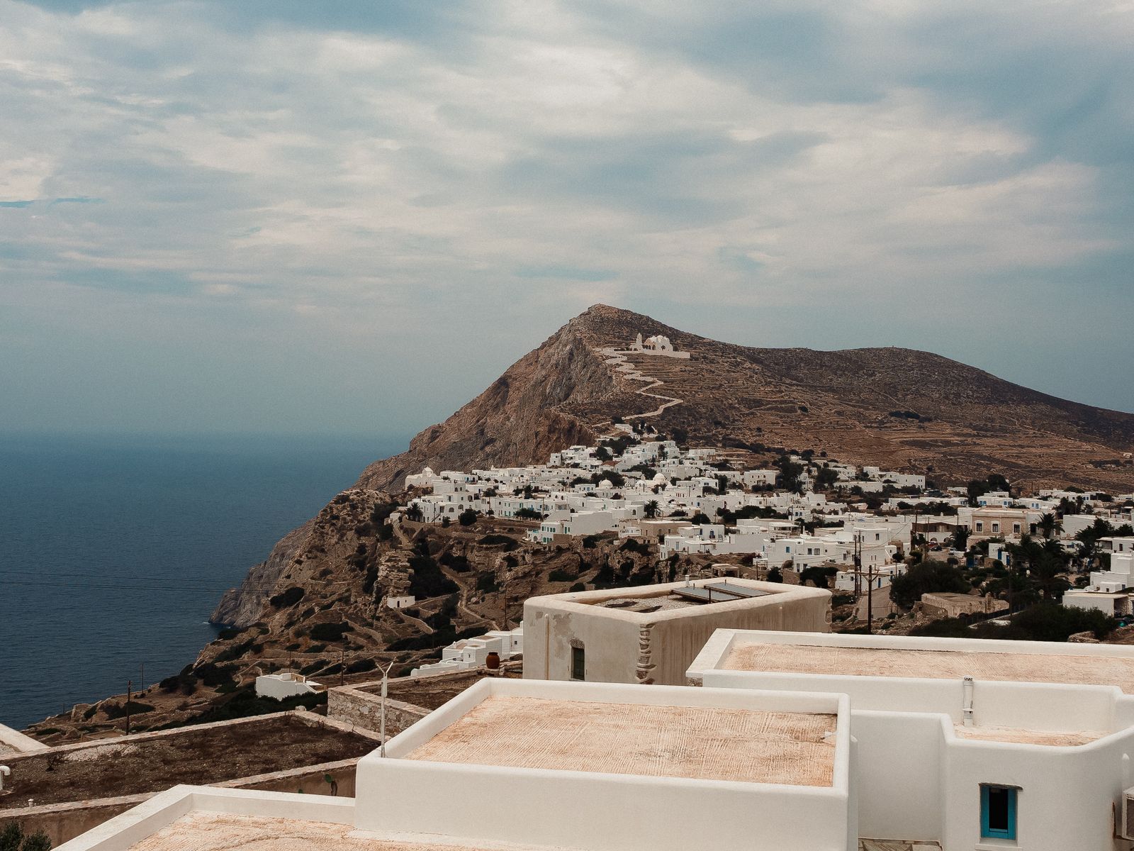 Folegandros'ta kayalık kıyı üzerinde beyaz evler ve Ege Denizi